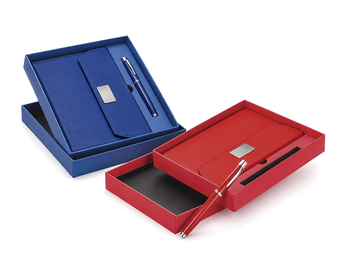Kit executivo composto por caderneta e caneta, ideal para ações corporativas e eventos empresariais. A caderneta conta com capa em PU, fecho magnético, detalhe metálico na aba, marcador de páginas em fita de cetim e aproximadamente 96 folhas pautadas na cor marfim com espaço para datas. Acompanha caneta metálica com carga esferográfica preta de 0,8 mm e estojo em papelão com berço para acomodação, agregando praticidade e apresentação diferenciada ao conjunto.