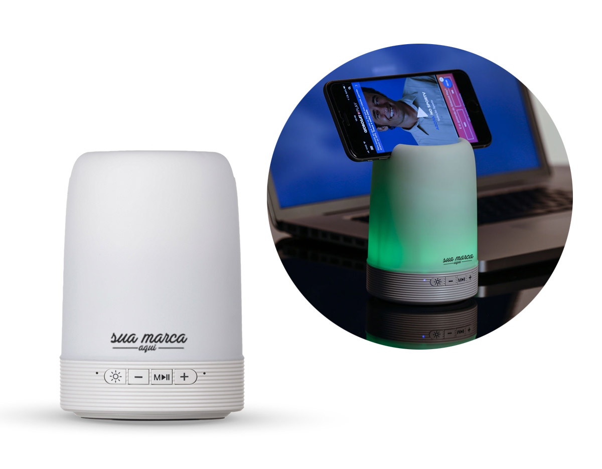 Caixa de som multimídia com luzes, suporte para celular e porta caneta. Material plástico resistente na cor branca fosca, parte superior com falante vazado na área interna, pode ser utilizado como porta caneta ou suporte para celular. 