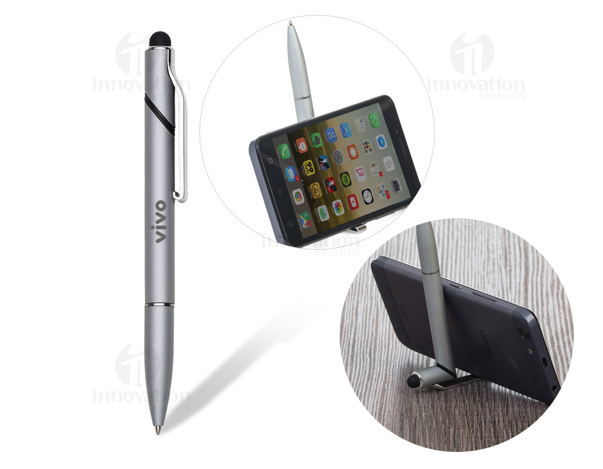 Caneta semimetal base para celular e com ponteira touch. Corpo colorido com detalhes prata, parte superior aonde fica o clip plástico é giratória