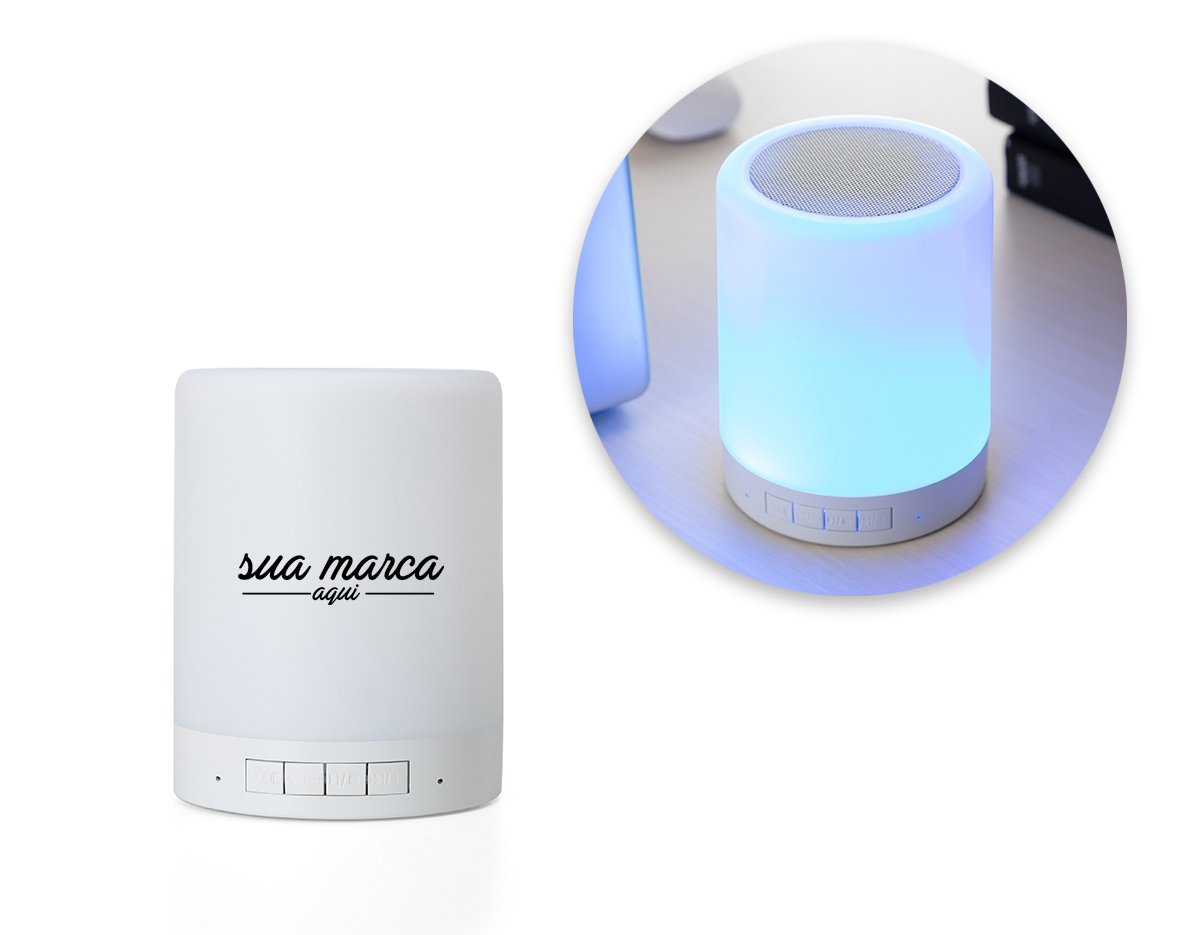 Caixa de som multimídia com luzes. Material plástico resistente na cor branca fosca, parte superior com falante e sensor touch para troca de luzes.
