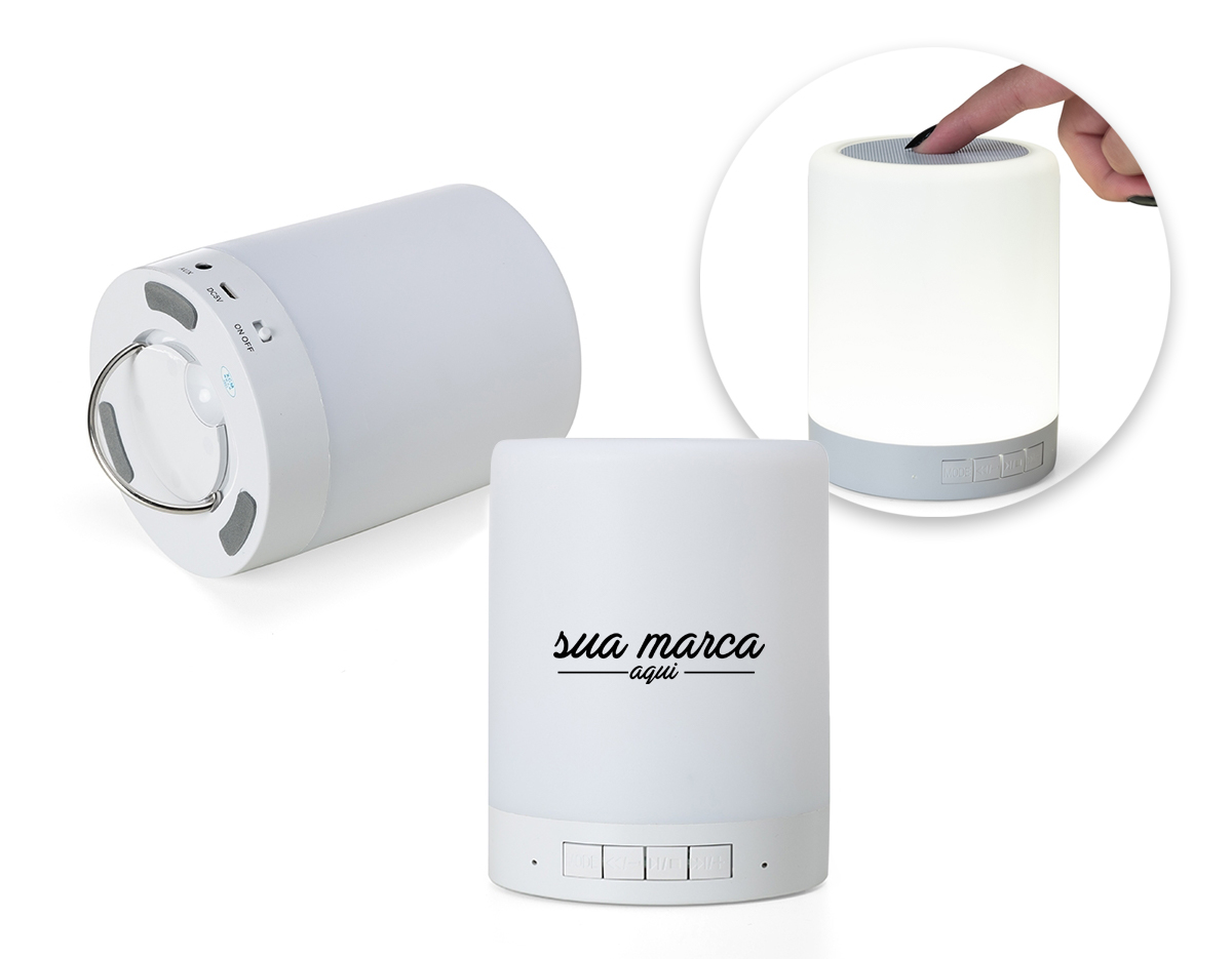 Caixa de som multimídia com luzes. Material plástico resistente na cor branca fosca, parte superior com falante e sensor touch para troca de luzes.
