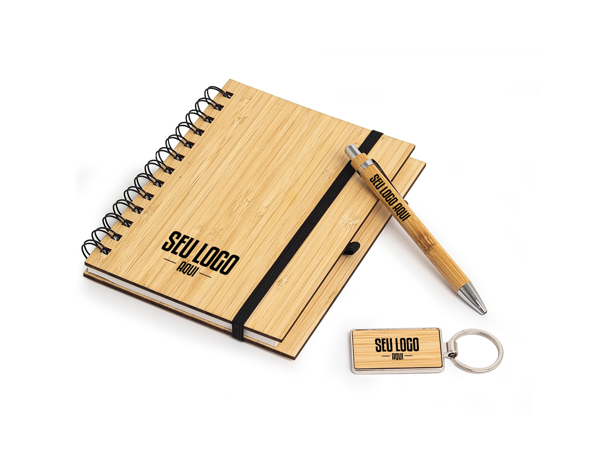 Kit executivo ecológico 3 peças em estojo de papelão. Contém: chaveiro de bambu com detalhe em metal, caderneta em bambu, capa dura, com aproximadamente 65 folhas brancas pautadas, caneta de bambu com clipe metálico, elástico para lacre e suporte para caneta em nylon.