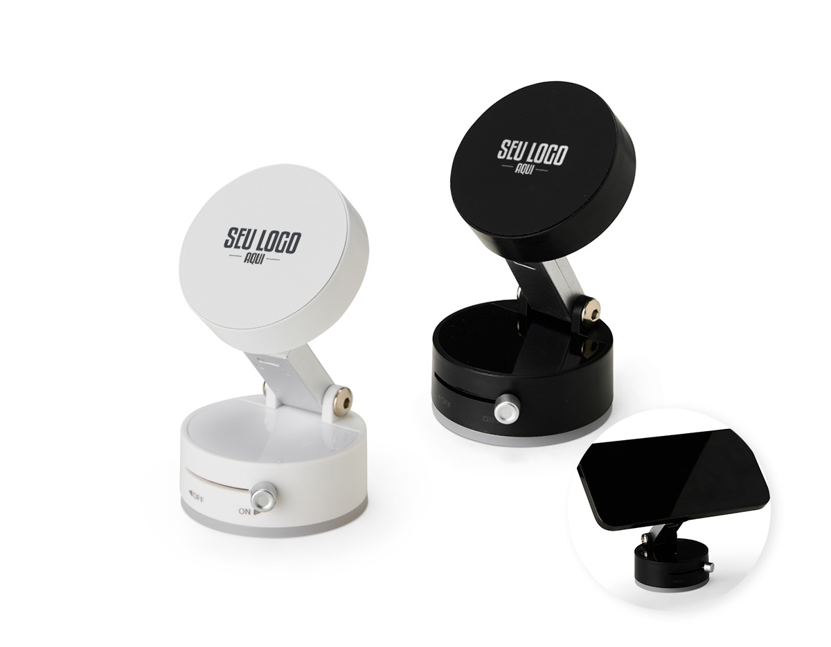 Um suporte compacto e funcional para acomodar smartphones de maneira simples em superfícies lisas. Feito em plástico, Possuí ajuste em diferentes ângulos de inclinação. Conta com uma ventosa retrátil via chave seletora para fixação do suporte em superfícies lisas, ideal para vidros e painéis de carros, mesas e outros ambientes através do adesivo em policarbonato que o acompanha. Apresenta encaixe magnético para posicionar o aparelho na vertical ou horizontal de forma prática aparelhos com suporte às funções magnéticas ou com o auxílio do anel adaptador que pode ser colado na parte interna de capas de celulares.