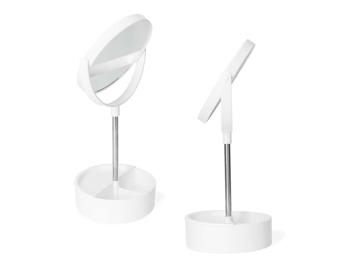 Espelho de mesa dupla face giratório com design moderno e funcional. Com base e moldura de plástico e pedestal de alumínio, ele é fácil de montar e adequa-se bem a qualquer ambiente. Sua base contém três divisórias para guardar objetos diversos.