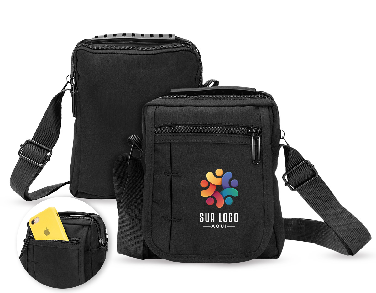 Bolsa de ombro confeccionada em nylon impermeável com alça ajustável para ombros e outra para mão. incluindo um bolso antifurto, um localizado na aba frontal, ambos com fechamento em zíper, e outro na parte interna da aba.